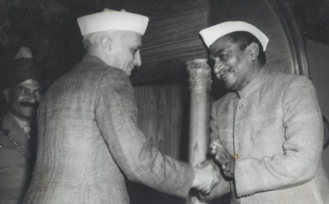 Rajendra Prasad shakes Nehru’s hand after signing the Constitution of India.
