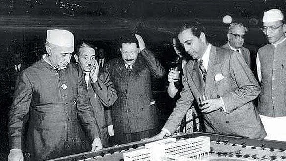 Nehru and Homi J. Bhabha examine a model of an atomic research facility.