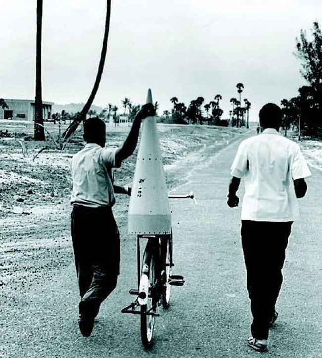 C.R. Sathya and Velappan Nair carry a rocket nose cone to the launch pad, Thumba Equatorial Rocket Launching Station.